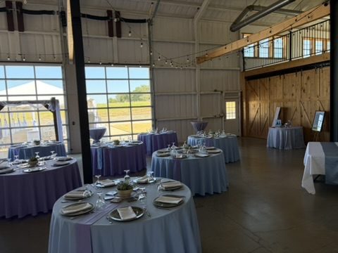 Tables under string lights with the loft in the background